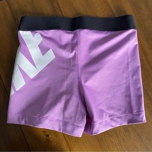 Nike pro athletic shorts purple with white logo